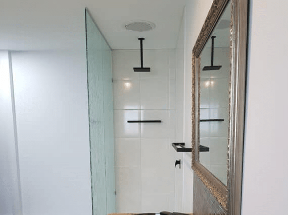 Minimalist bathroom with frameless shower screen